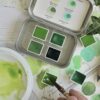 Green watercolour palette - A pocket sized tin of four shades of green ranging from light, yellowish green, earthy mid tone to a dark bluish green. by Art Scribe