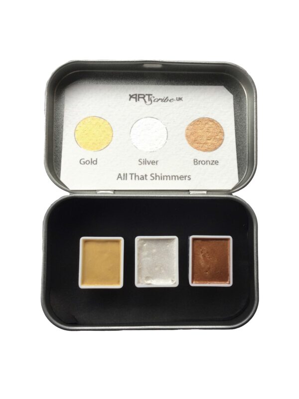 open tin showing three half pans of watercolour paint gold silver and bronze. The lid contains a hand painted swatch with gold, silver and bronze colours shining. The label tell you it is the All That Shimmers set.